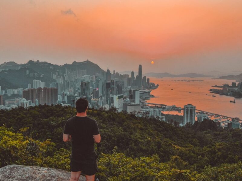 sunset over modern Hong Kong coastal city